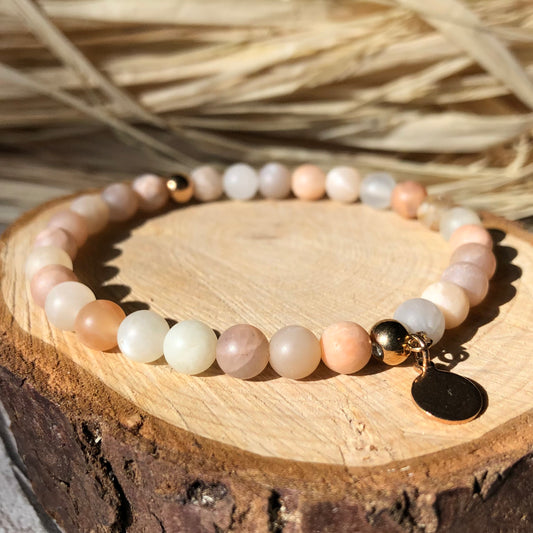 A multicolored sunstone beaded bracelet with rose gold stainless steel spacer beads